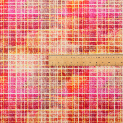 This fabric features an intricate, layered plaid pattern that blends warm tones of red, orange, yellow, and deep pink. The design has a slightly blurred, watercolour effect with a dense grid of fine white and gold lines overlapping the vibrant colours.