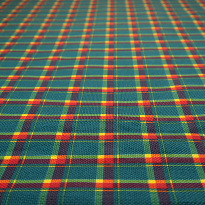This fabric features a woven plaid pattern dominated by a deep teal background, intersected by a structured grid of thin horizontal and vertical lines in bright yellow, orange, and dark burgundy.
