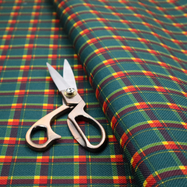 This fabric features a woven plaid pattern dominated by a deep teal background, intersected by a structured grid of thin horizontal and vertical lines in bright yellow, orange, and dark burgundy.