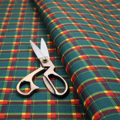 This fabric features a woven plaid pattern dominated by a deep teal background, intersected by a structured grid of thin horizontal and vertical lines in bright yellow, orange, and dark burgundy.