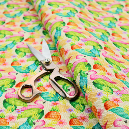This fabric features a tropical pattern on a light, neutral background, densely decorated with illustrations of bright pink flamingos, pineapples, lush green tropical leaves, and small purple and pink flowers.