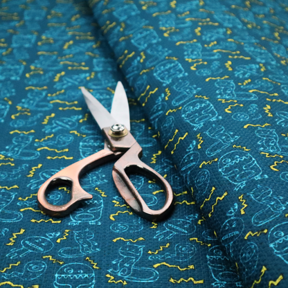 This fabric features a playful, dark teal background covered in a whimsical pattern of small, light blue line-art monsters and yellow zigzagging lightning bolt accents.