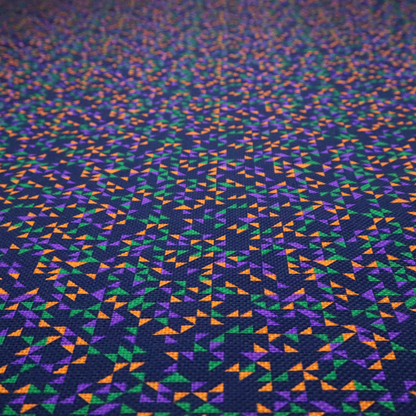 This fabric features a dense geometric pattern of tiny, randomly oriented triangles in shades of purple, green, and orange scattered across a solid dark navy blue background.