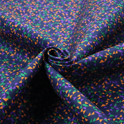 This fabric features a dense geometric pattern of tiny, randomly oriented triangles in shades of purple, green, and orange scattered across a solid dark navy blue background.