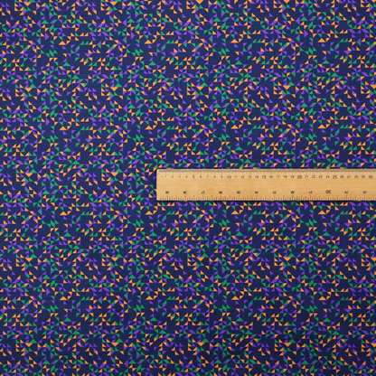 This fabric features a dense geometric pattern of tiny, randomly oriented triangles in shades of purple, green, and orange scattered across a solid dark navy blue background.