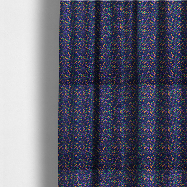 The fabric used to create these made-to-measure curtains is a fabric features a dense geometric pattern of tiny, randomly oriented triangles in shades of purple, green, and orange scattered across a solid dark navy blue background.
