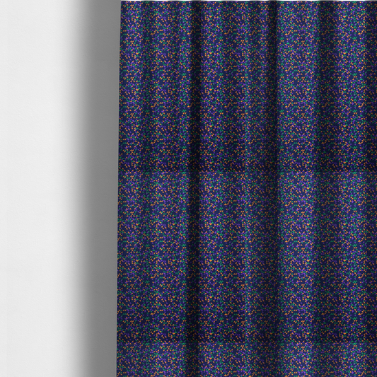 The fabric used to create these made-to-measure curtains is a fabric features a dense geometric pattern of tiny, randomly oriented triangles in shades of purple, green, and orange scattered across a solid dark navy blue background.