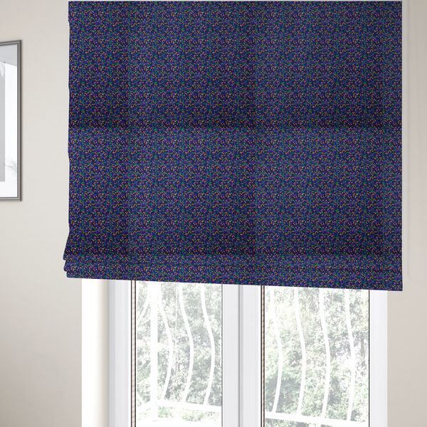 The fabric used to create these Roman blinds is a fabric features a dense geometric pattern of tiny, randomly oriented triangles in shades of purple, green, and orange scattered across a solid dark navy blue background.