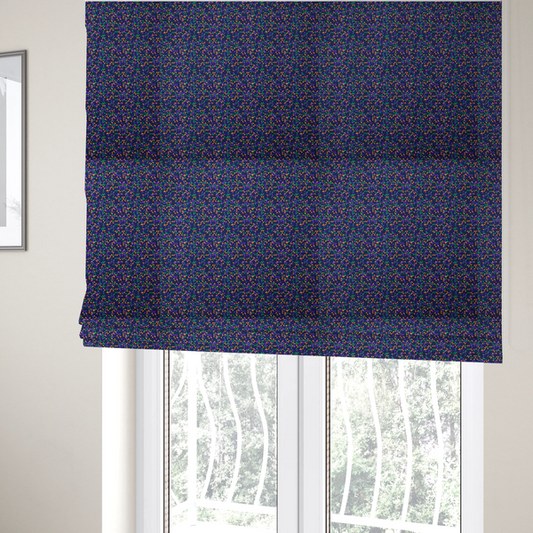The fabric used to create these Roman blinds is a fabric features a dense geometric pattern of tiny, randomly oriented triangles in shades of purple, green, and orange scattered across a solid dark navy blue background.