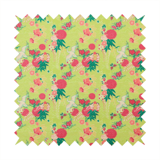 This fabric features a whimsical, Chinoiseries-inspired pattern on a bright chartreuse-green background, repeating illustrations of white cranes, large dark pink pom-pom flowers, and leafy green ferns.