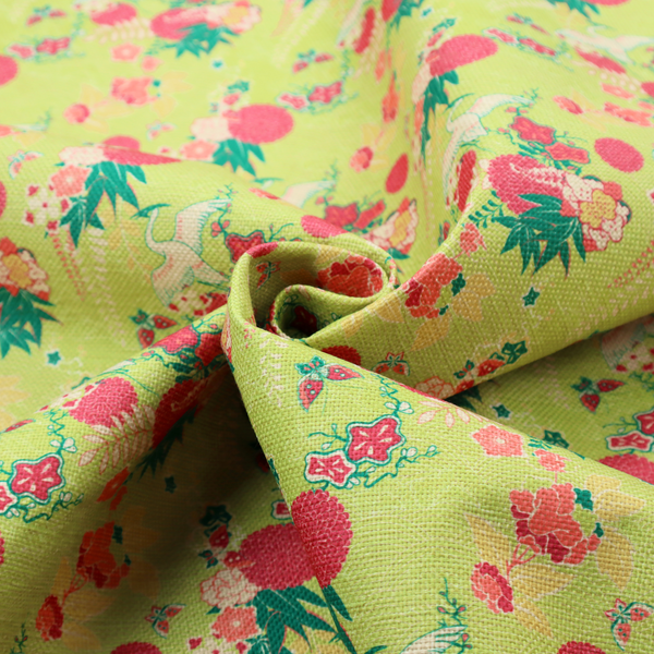 This fabric features a whimsical, Chinoiseries-inspired pattern on a bright chartreuse-green background, repeating illustrations of white cranes, large dark pink pom-pom flowers, and leafy green ferns.