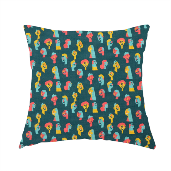 The fabric used to create this handmade cushion is a fabric features a whimsical, repeating pattern on a dark teal background, decorated with stylized, colourful illustrations of diverse human faces in shades of bright yellow, light blue, and coral pink.