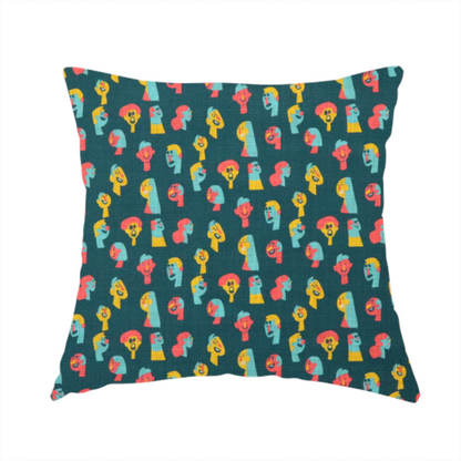 The fabric used to create this handmade cushion is a fabric features a whimsical, repeating pattern on a dark teal background, decorated with stylized, colourful illustrations of diverse human faces in shades of bright yellow, light blue, and coral pink.