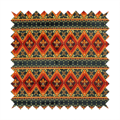 A fabric print featuring a repeating Southwestern geometric pattern. The design consists of horizontal bands with large red, orange, and yellow diamond motifs mixed with thin charcoal black borders detailed with small, delicate yellow tribal symbols.