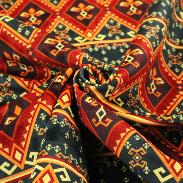 A fabric print featuring a repeating Southwestern geometric pattern. The design consists of horizontal bands with large red, orange, and yellow diamond motifs mixed with thin charcoal black borders detailed with small, delicate yellow tribal symbols.