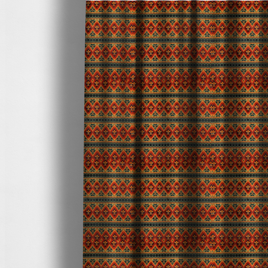 The fabric used to create these made-to-measure curtains is a fabric print featuring a repeating Southwestern geometric pattern. The design consists of horizontal bands with large red, orange, and yellow diamond motifs mixed with thin charcoal black borders detailed with small, delicate yellow tribal symbols.
