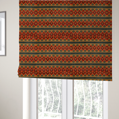 The fabric used to create these Roman blinds is a fabric print featuring a repeating Southwestern geometric pattern. The design consists of horizontal bands with large red, orange, and yellow diamond motifs mixed with thin charcoal black borders detailed with small, delicate yellow tribal symbols.
