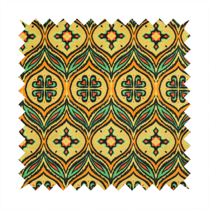 Fabric print featuring a repeating retro ikat ogee pattern. The geometric design displays a lattice of mustard yellow onion arches, green leaf shapes, and four-leaf clover medallions outlined in fuzzy black brushstrokes with pops of coral orange.