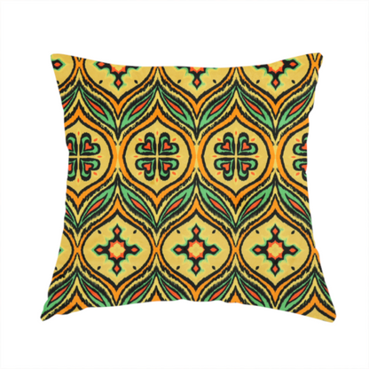 The fabric used to create this handmade cushion is a print featuring a repeating retro ikat ogee pattern. The geometric design displays a lattice of mustard yellow onion arches, green leaf shapes, and four-leaf clover medallions outlined in fuzzy black brushstrokes with pops of coral orange.
