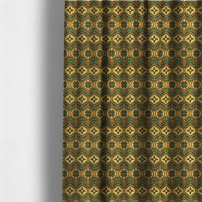 The fabric used to create these made-to-measure curtains is a print featuring a repeating retro ikat ogee pattern. The geometric design displays a lattice of mustard yellow onion arches, green leaf shapes, and four-leaf clover medallions outlined in fuzzy black brushstrokes with pops of coral orange.