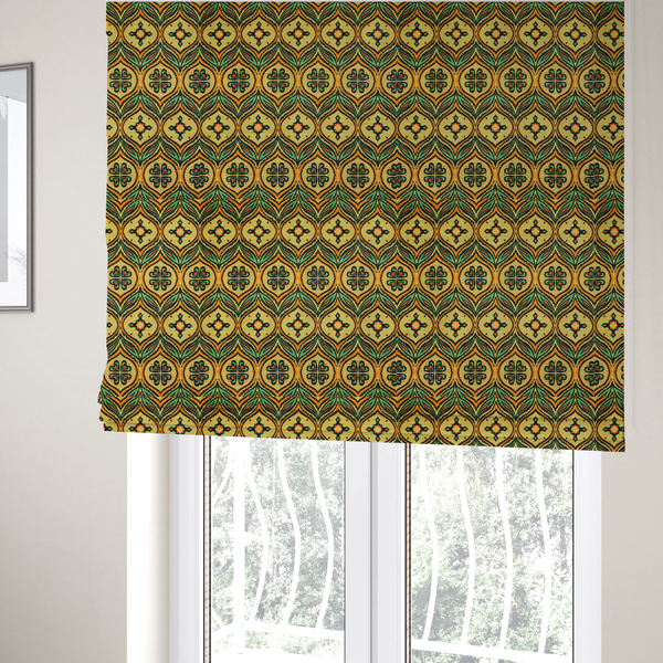 The fabric used to create these Roman blinds is a print featuring a repeating retro ikat ogee pattern. The geometric design displays a lattice of mustard yellow onion arches, green leaf shapes, and four-leaf clover medallions outlined in fuzzy black brushstrokes with pops of coral orange.