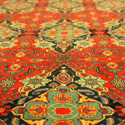 Fabric print featuring an intricate, repeating Persian rug or Moroccan mosaic design. The pattern displays large geometric medallions and scrolling damask shapes in vibrant red, jade green, and warm gold.