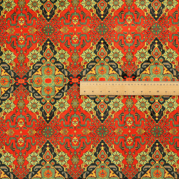 Fabric print featuring an intricate, repeating Persian rug or Moroccan mosaic design. The pattern displays large geometric medallions and scrolling damask shapes in vibrant red, jade green, and warm gold.