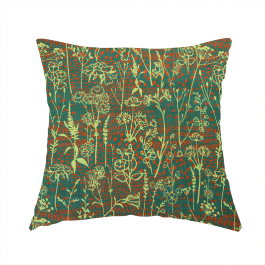 The fabric used to create this handmade cushion is a print featuring a whimsical wildflower meadow pattern. The design showcases delicate lime-green line art sketches of slender stems and blossoms over a deep teal-green background layered with small, textured terracotta orange dashes.