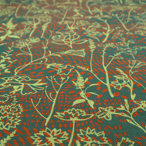 Fabric print featuring a whimsical wildflower meadow pattern. The design showcases delicate lime-green line art sketches of slender stems and blossoms over a deep teal-green background layered with small, textured terracotta orange dashes.