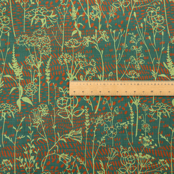 Fabric print featuring a whimsical wildflower meadow pattern. The design showcases delicate lime-green line art sketches of slender stems and blossoms over a deep teal-green background layered with small, textured terracotta orange dashes.