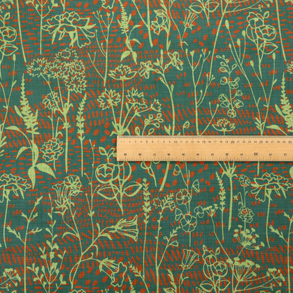 Fabric print featuring a whimsical wildflower meadow pattern. The design showcases delicate lime-green line art sketches of slender stems and blossoms over a deep teal-green background layered with small, textured terracotta orange dashes.