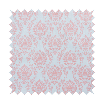 Fabric print featuring a classic, repeating vintage damask pattern. The traditional ornate floral and acanthus leaf motifs are printed in a soft blush pink over a light, pastel icy blue background.