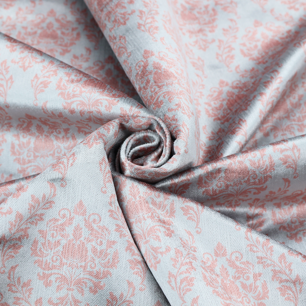 Fabric print featuring a classic, repeating vintage damask pattern. The traditional ornate floral and acanthus leaf motifs are printed in a soft blush pink over a light, pastel icy blue background.