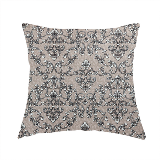 The fabric used to create this handmade cushion is featuring a repeating traditional damask pattern in white and dark grey outlines over a textured, light taupe background.