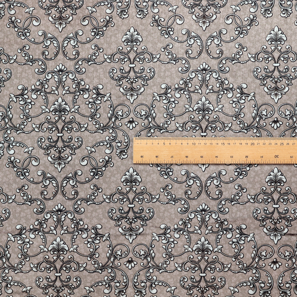 Fabric featuring a repeating traditional damask pattern in white and dark grey outlines over a textured, light taupe background.