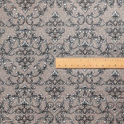 Fabric featuring a repeating traditional damask pattern in white and dark grey outlines over a textured, light taupe background.