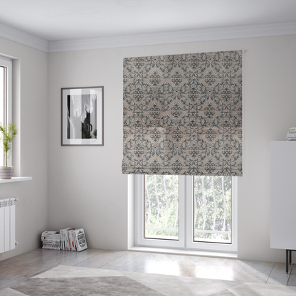 The fabric used to create these Roman blinds is featuring a repeating traditional damask pattern in white and dark grey outlines over a textured, light taupe background.