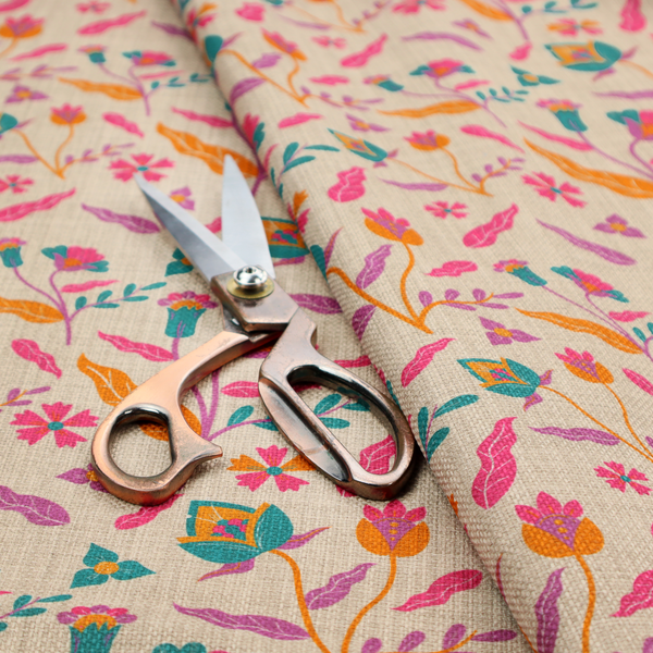 Fabric featuring a vibrant, repeating floral pattern with pink, orange, and teal blossoms and leaves on a neutral, linen-textured beige background.