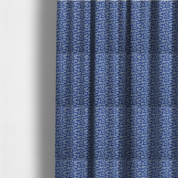 The fabric used to create these made-to-measure curtains is featuring a vibrant, repeating geometric pattern of light grey, abstract leaf or comb-like blocks closely packed on a royal blue background.