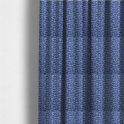 The fabric used to create these made-to-measure curtains is featuring a vibrant, repeating geometric pattern of light grey, abstract leaf or comb-like blocks closely packed on a royal blue background.