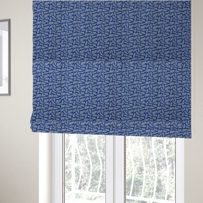 The fabric used to create these Roman blinds is featuring a vibrant, repeating geometric pattern of light grey, abstract leaf or comb-like blocks closely packed on a royal blue background.