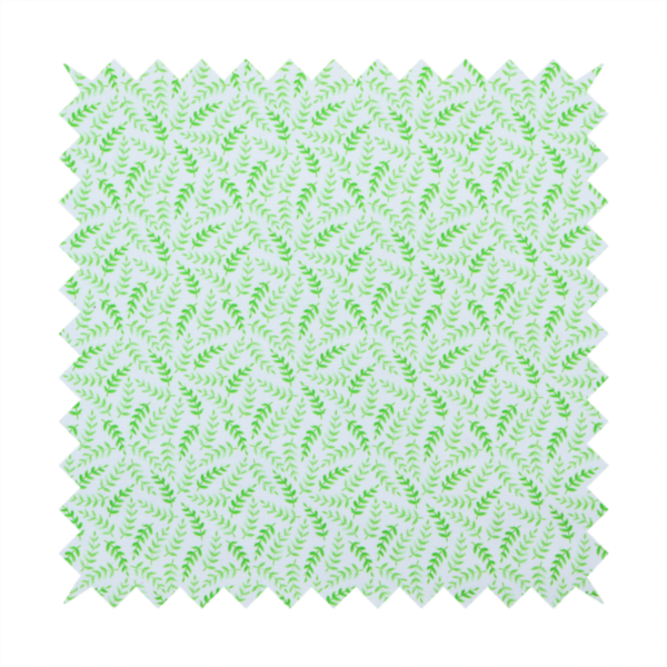 Fabric featuring a dense, repeating pattern of small, vibrant lime green leafy sprigs and fern-like fronds on a crisp white background.