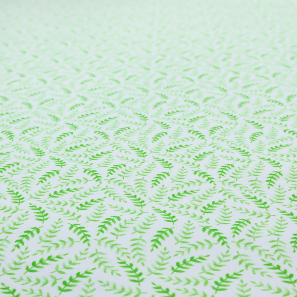 Fabric featuring a dense, repeating pattern of small, vibrant lime green leafy sprigs and fern-like fronds on a crisp white background.