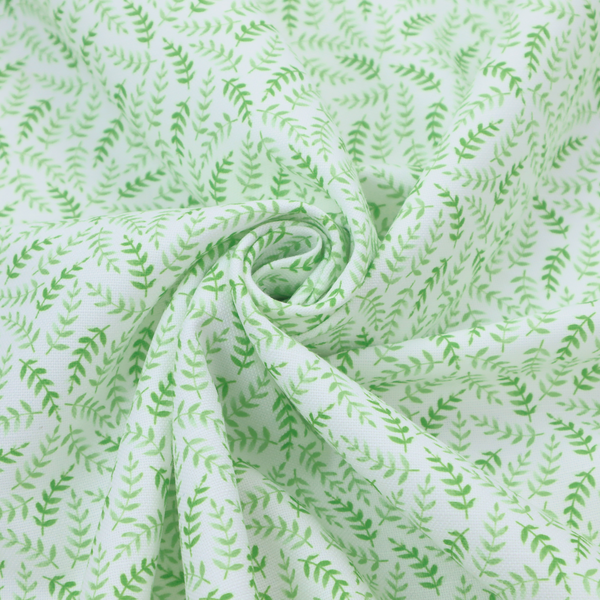 Fabric featuring a dense, repeating pattern of small, vibrant lime green leafy sprigs and fern-like fronds on a crisp white background.