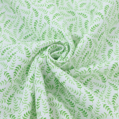 Fabric featuring a dense, repeating pattern of small, vibrant lime green leafy sprigs and fern-like fronds on a crisp white background.