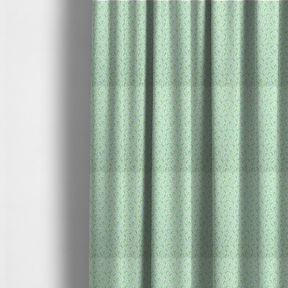 The fabric used to create these made-to-measure curtains is featuring a dense, repeating pattern of small, vibrant lime green leafy sprigs and fern-like fronds on a crisp white background.