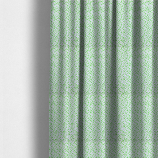 The fabric used to create these made-to-measure curtains is featuring a dense, repeating pattern of small, vibrant lime green leafy sprigs and fern-like fronds on a crisp white background.