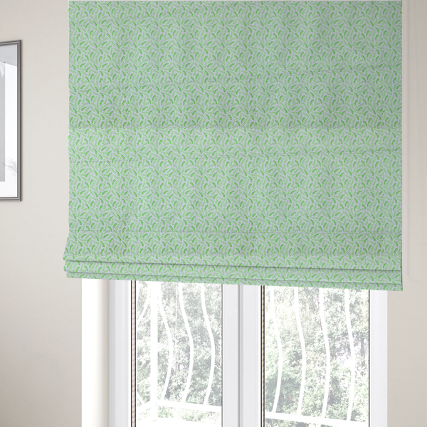 The fabric used to create these Roman blinds is featuring a dense, repeating pattern of small, vibrant lime green leafy sprigs and fern-like fronds on a crisp white background.