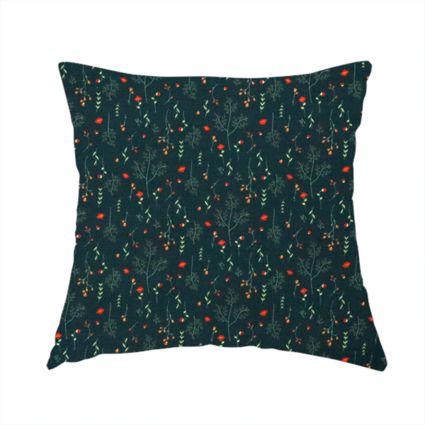 The fabric used to create this handmade cushion is a dark forest green fabric featuring a delicate, scattered botanical print. The pattern includes fine, wispy light green twigs, tiny light green leaves, and small, vibrant red wildflowers and buds spread evenly across the textured dark background.