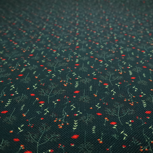 Dark forest green fabric featuring a delicate, scattered botanical print. The pattern includes fine, wispy light green twigs, tiny light green leaves, and small, vibrant red wildflowers and buds spread evenly across the textured dark background.